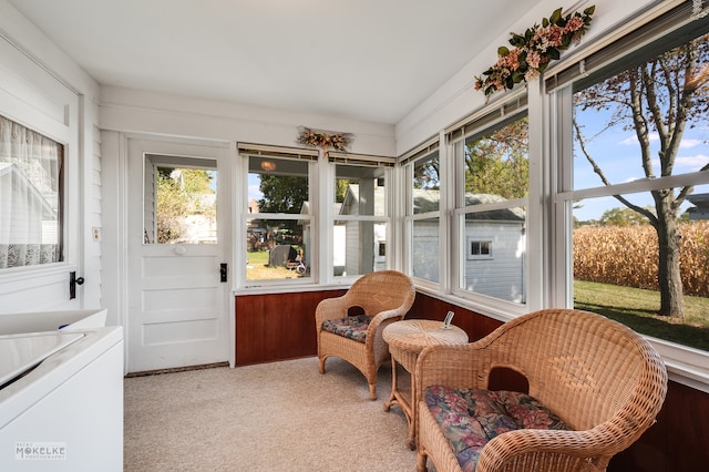 sunroom / solarium with washing machine and clothes dryer