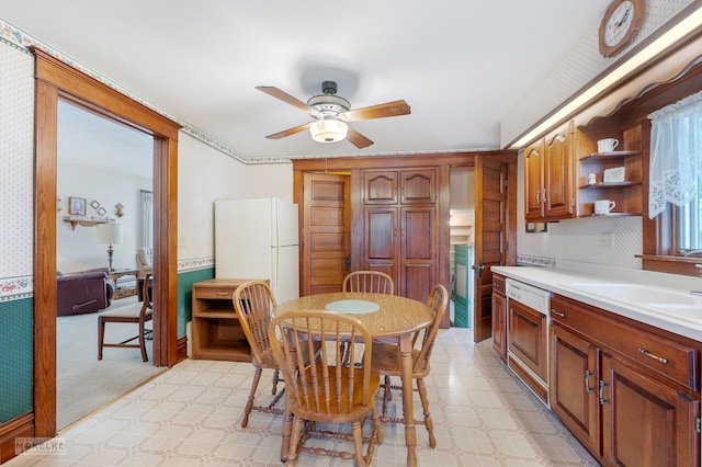 dining space featuring ceiling fan and sink