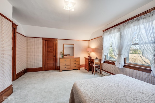 bedroom with baseboards, a baseboard radiator, carpet, vaulted ceiling, and wallpapered walls