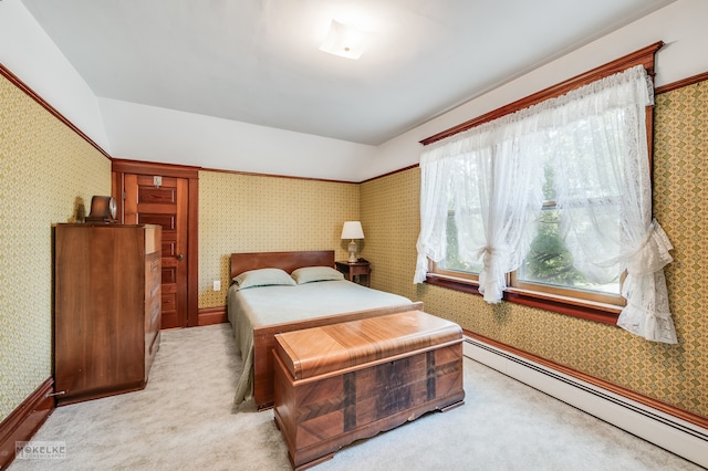 carpeted bedroom featuring a baseboard heating unit