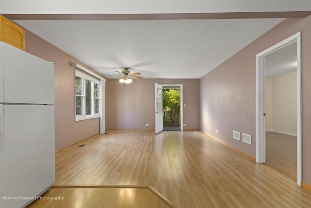 unfurnished living room featuring light wood-type flooring and ceiling fan