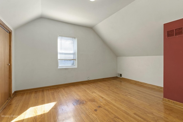 bonus room featuring light hardwood / wood-style flooring and vaulted ceiling