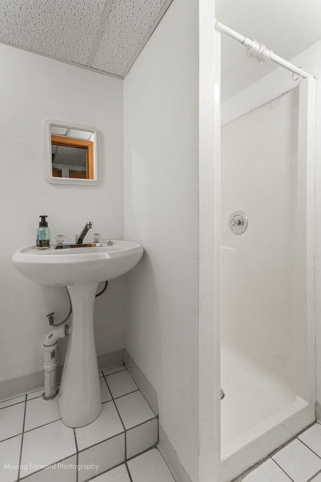 bathroom with tile patterned floors and a shower