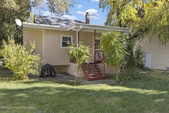 rear view of property with a yard