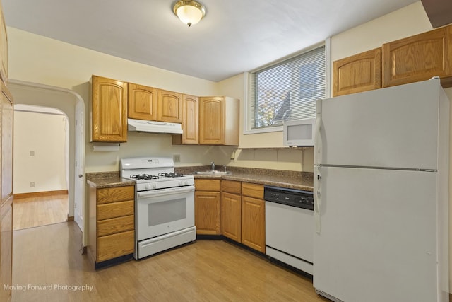 kitchen featuring sink, light hardwood / wood-style floors, and white appliances