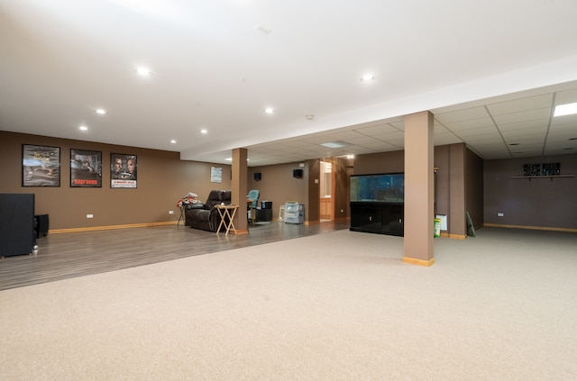 interior space featuring a drop ceiling and carpet floors