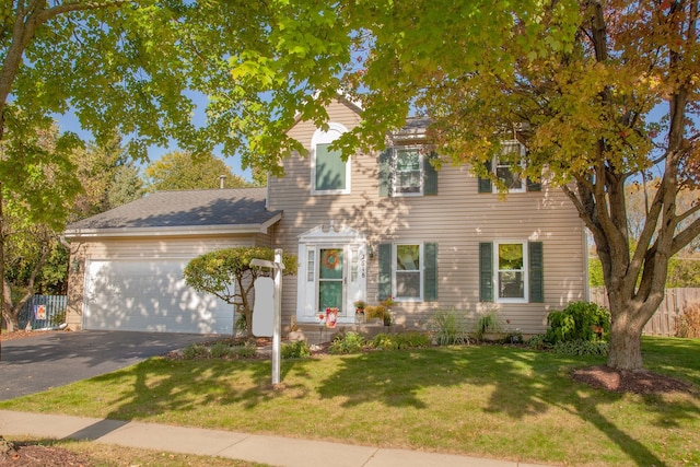 colonial inspired home with a front lawn and a garage