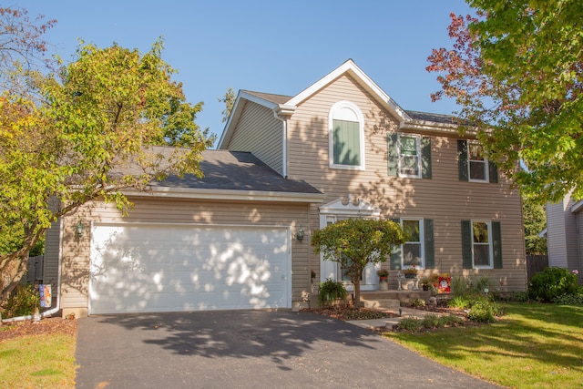 colonial house featuring a garage and a front yard