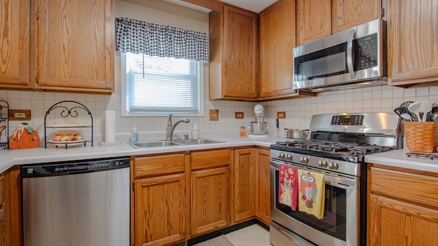 kitchen featuring stainless steel appliances, tasteful backsplash, and sink