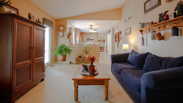 living room featuring light carpet, vaulted ceiling, and ceiling fan