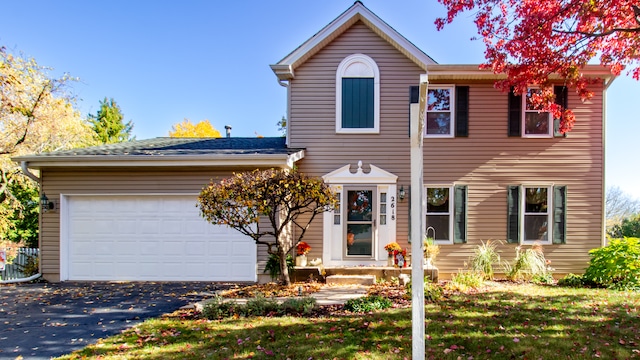 view of front of house featuring a garage and a front lawn