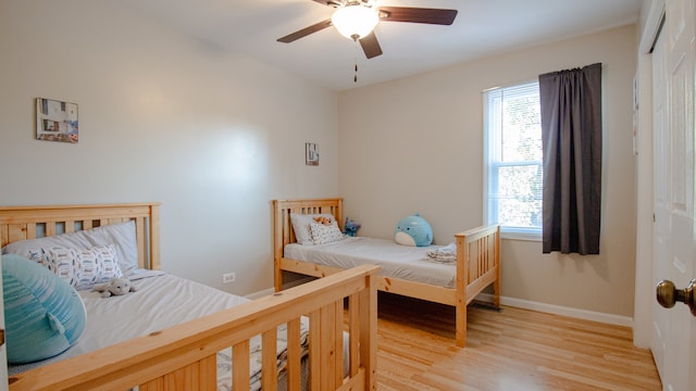 bedroom featuring light hardwood / wood-style flooring and ceiling fan