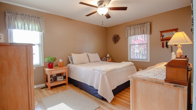 bedroom with light hardwood / wood-style flooring and ceiling fan