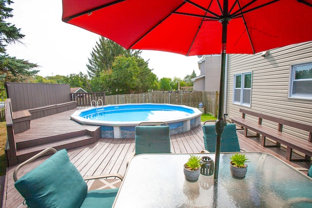 view of swimming pool with a deck