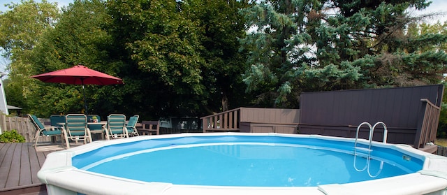 view of swimming pool with a wooden deck