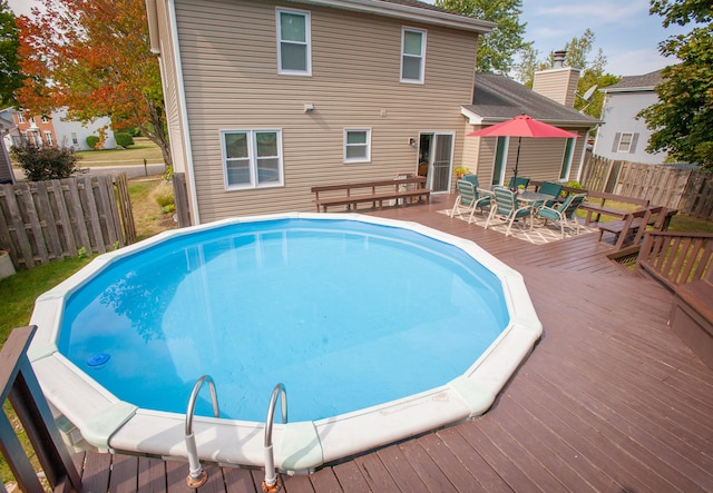 view of swimming pool featuring a deck