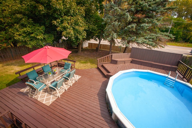 view of swimming pool with a deck