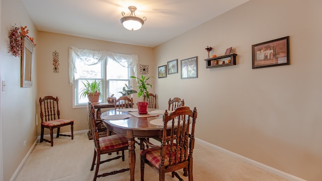 dining area with light colored carpet