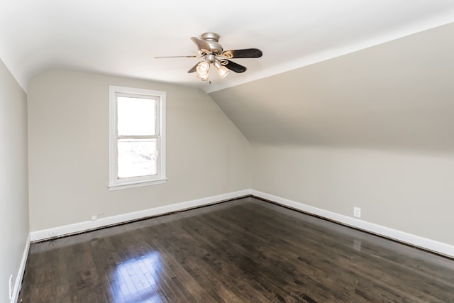 additional living space featuring lofted ceiling, dark hardwood / wood-style floors, and ceiling fan