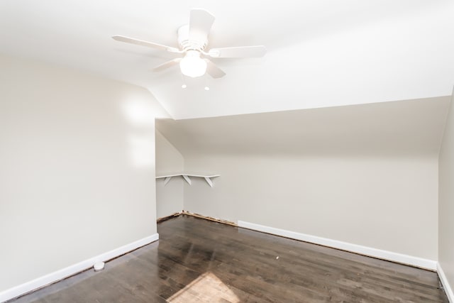 additional living space featuring dark wood-type flooring, lofted ceiling, and ceiling fan