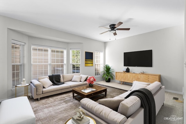 living room with ceiling fan and light colored carpet