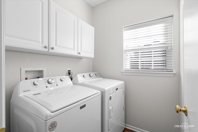 washroom featuring cabinets and washing machine and clothes dryer