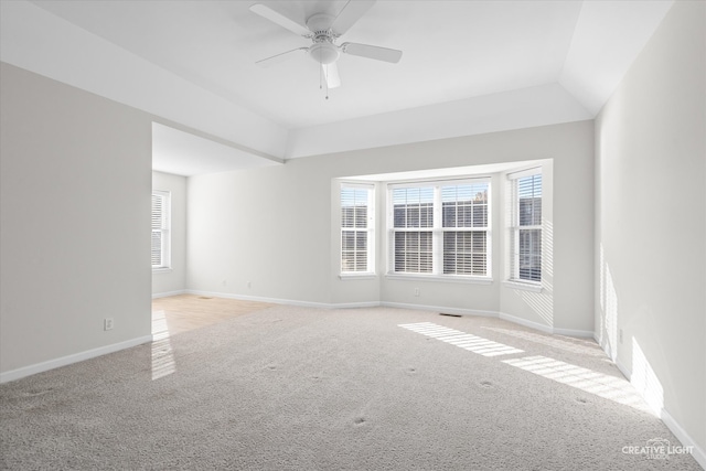 unfurnished room with ceiling fan, light colored carpet, and vaulted ceiling