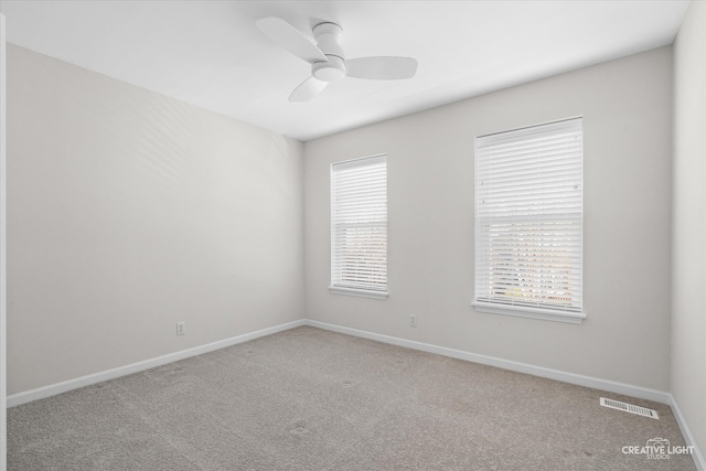 unfurnished room featuring ceiling fan and carpet floors