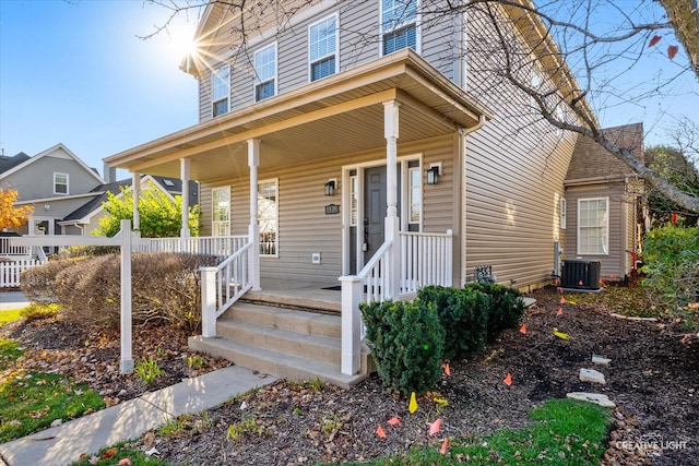 view of front of property with cooling unit and covered porch