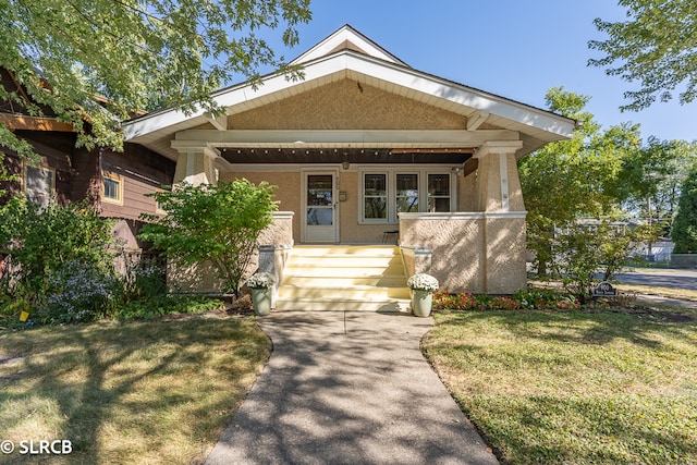 craftsman inspired home with a front yard and a porch