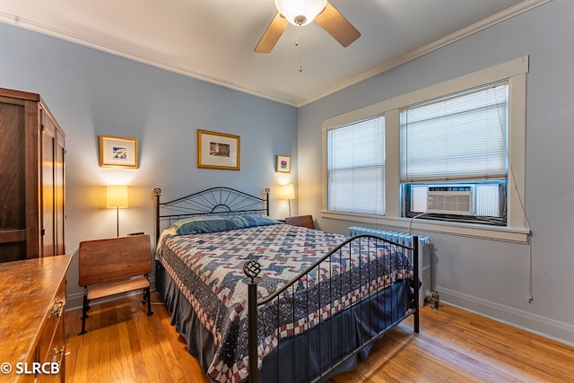 bedroom with crown molding, cooling unit, light hardwood / wood-style floors, and ceiling fan