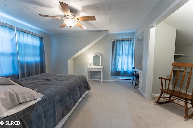 bedroom featuring baseboard heating, light colored carpet, and ceiling fan