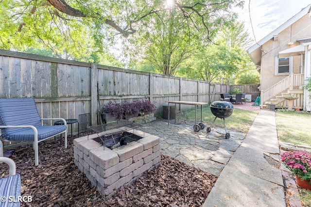 view of patio / terrace featuring an outdoor fire pit