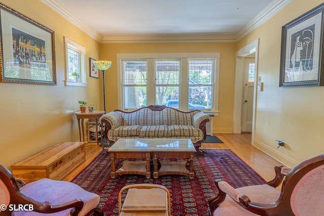 sitting room with crown molding and light wood-type flooring