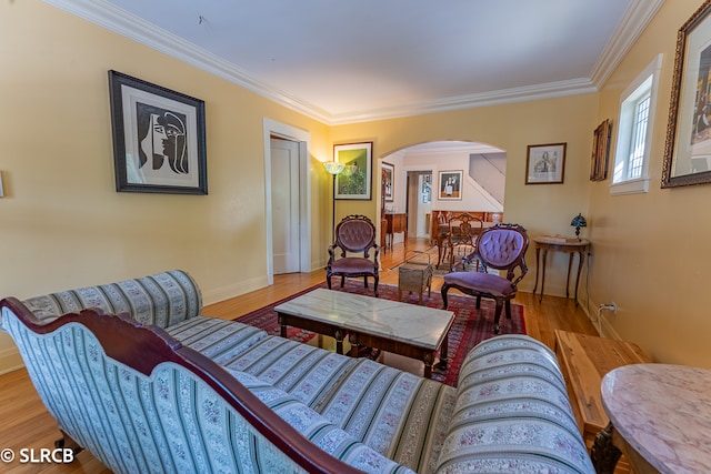 sitting room with light hardwood / wood-style flooring and ornamental molding