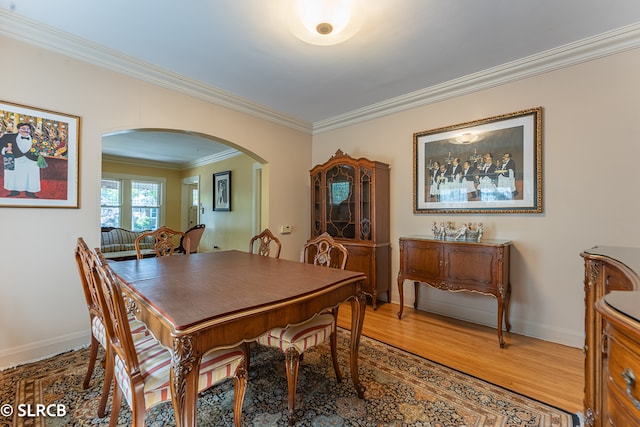 dining room featuring crown molding and hardwood / wood-style floors