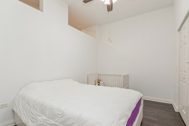 bedroom with ceiling fan, dark hardwood / wood-style flooring, radiator, and a closet