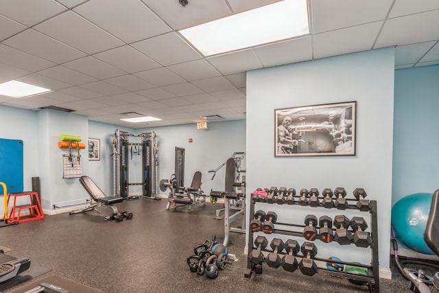 gym with a paneled ceiling