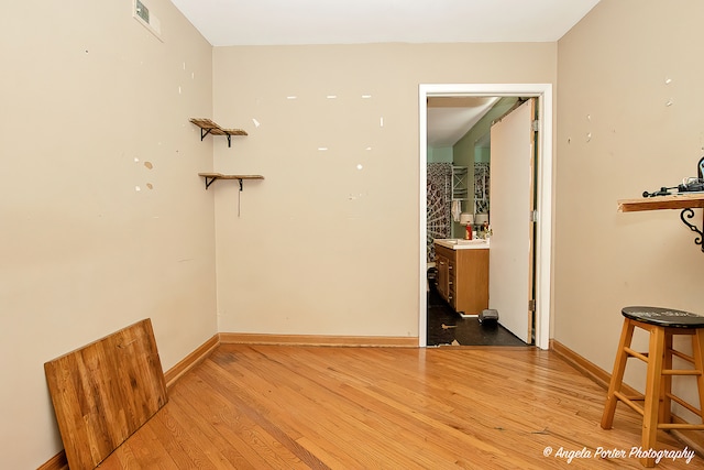 empty room with sink and light hardwood / wood-style floors