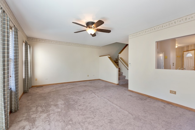 unfurnished living room featuring light carpet and ceiling fan