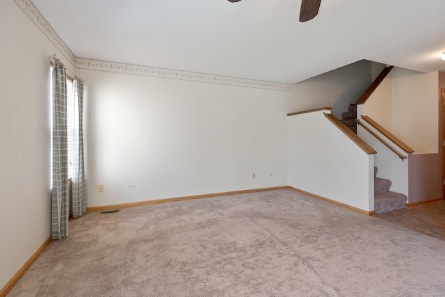 unfurnished living room with ceiling fan and carpet floors