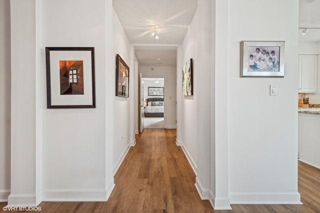 corridor with light hardwood / wood-style flooring