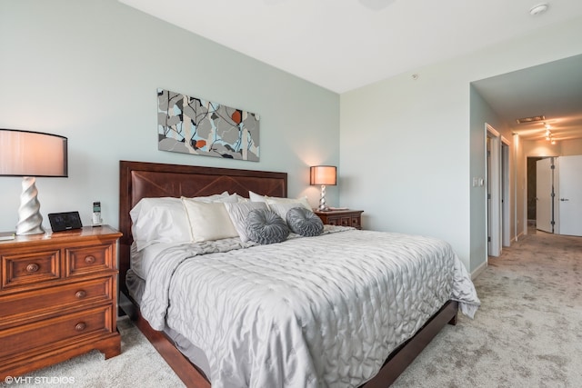 bedroom featuring light carpet