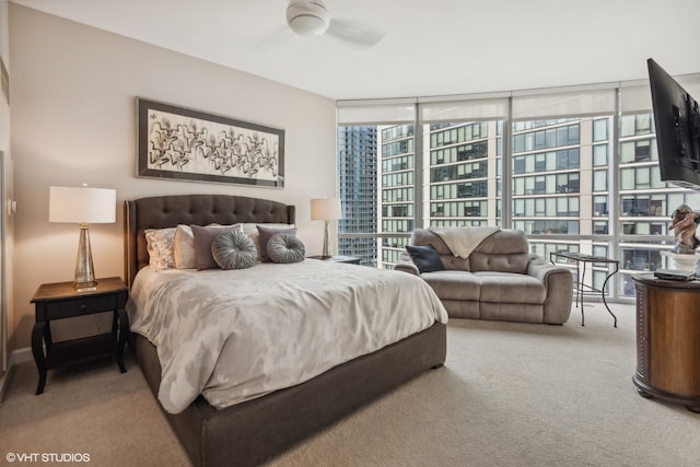 bedroom featuring ceiling fan, floor to ceiling windows, and carpet