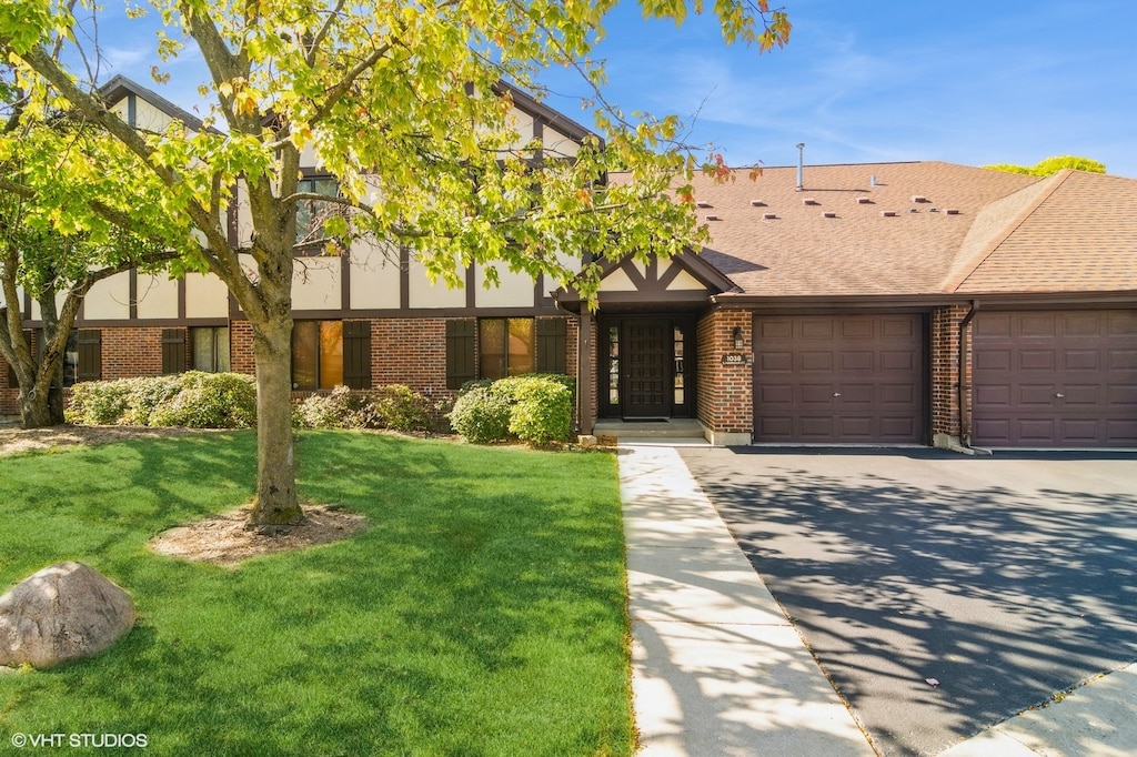 view of front of house featuring a garage and a front lawn