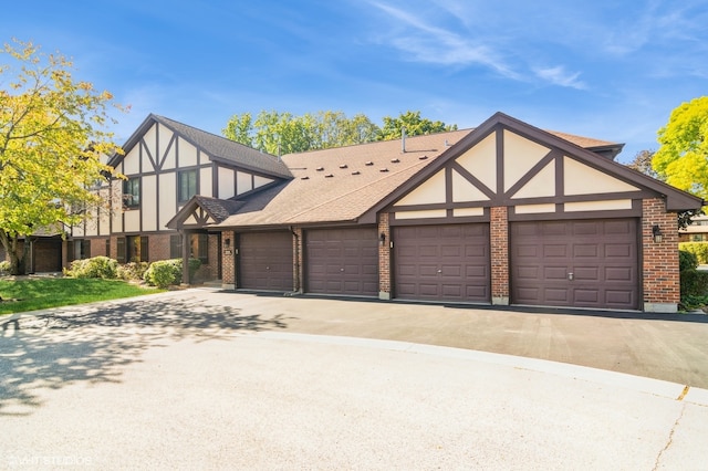 tudor house featuring a garage