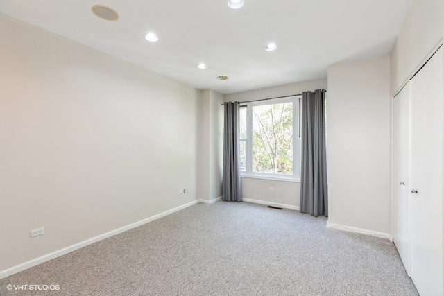 unfurnished bedroom with light colored carpet