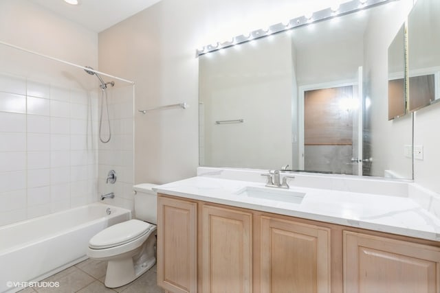 full bathroom featuring tiled shower / bath, tile patterned floors, vanity, and toilet