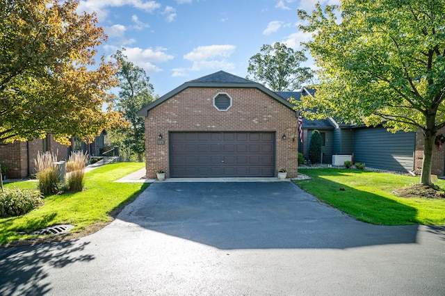 view of front of house featuring a front lawn and a garage