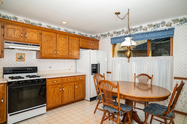 kitchen with pendant lighting and white appliances